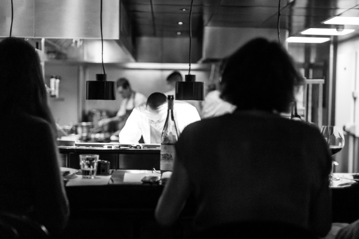 chefs working inside a restaurant kitchen