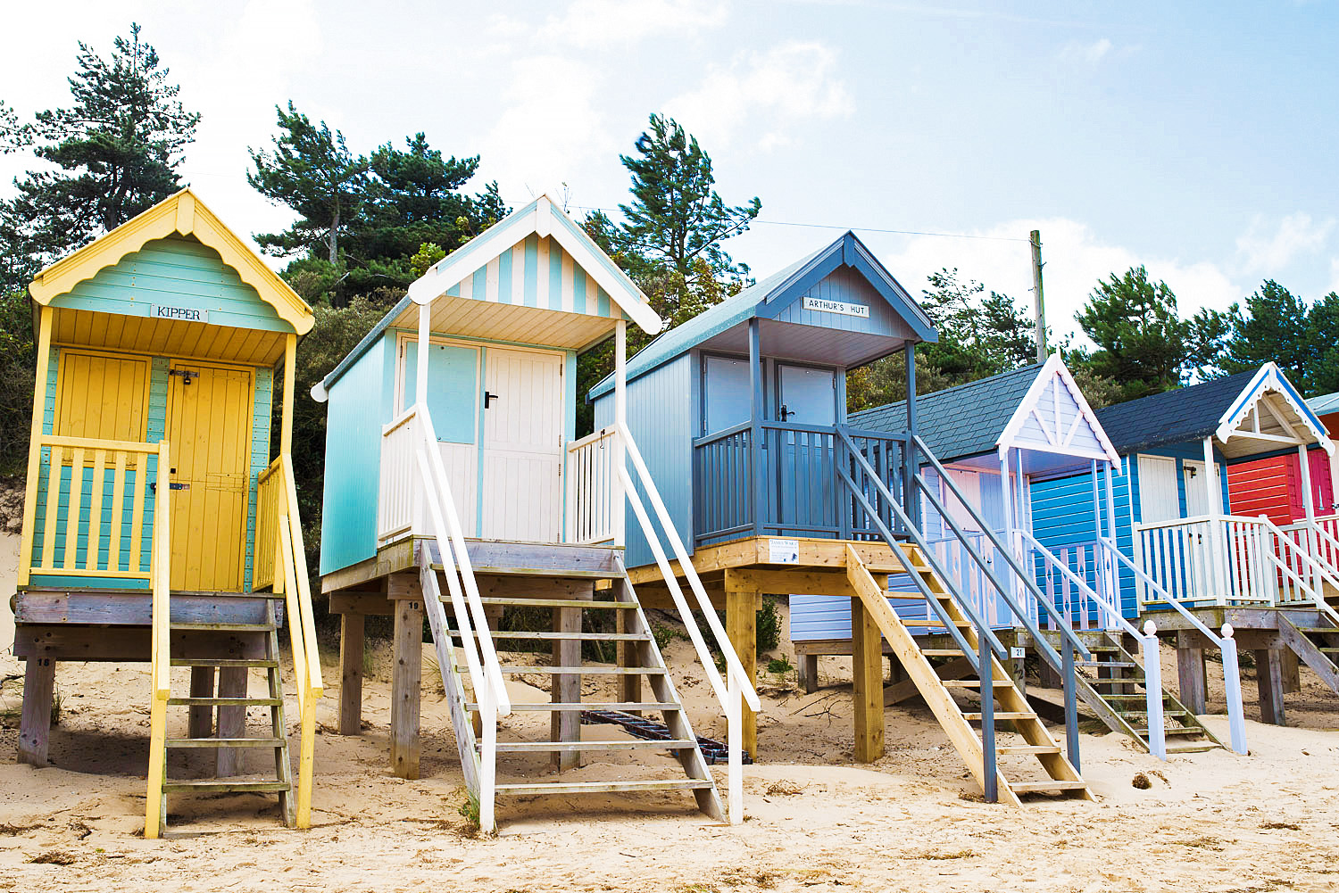 Beach huts on sand at Wells-next-the-Sea in Norfolk, England