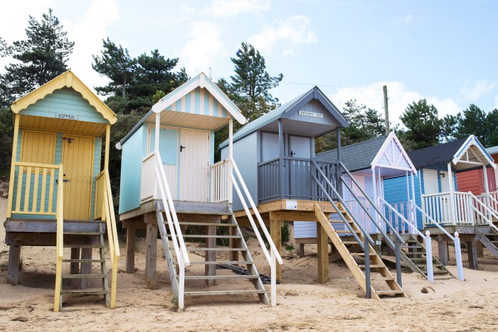 Beach huts on sand at Wells-next-the-Sea in Norfolk, England Beach huts on sand at Wells-next-the-Sea in Norfolk, England