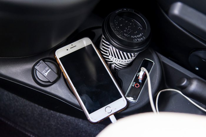 Phone charging and a coffee cup inside a Fiat car 500 Phone charging and a coffee cup inside a Fiat car 500