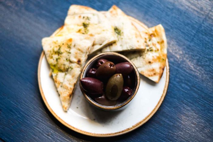 Olives and pita bread as appetizer at a Greek restaurant in London
