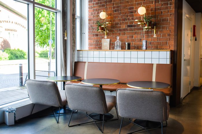 Tables in front of brown wall and window in Lofbergs coffee shop in Sweden Tables in front of brown wall and window in Lofbergs coffee shop in Sweden