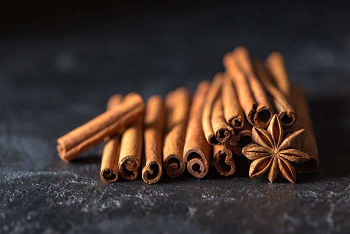 Cinnamon sticks star anise on a black counter Cinnamon sticks star anise on a black counter