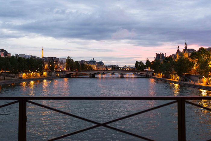 Sunset view of Paris and the river Seine from the pedestrian bridge Pont des Arts
