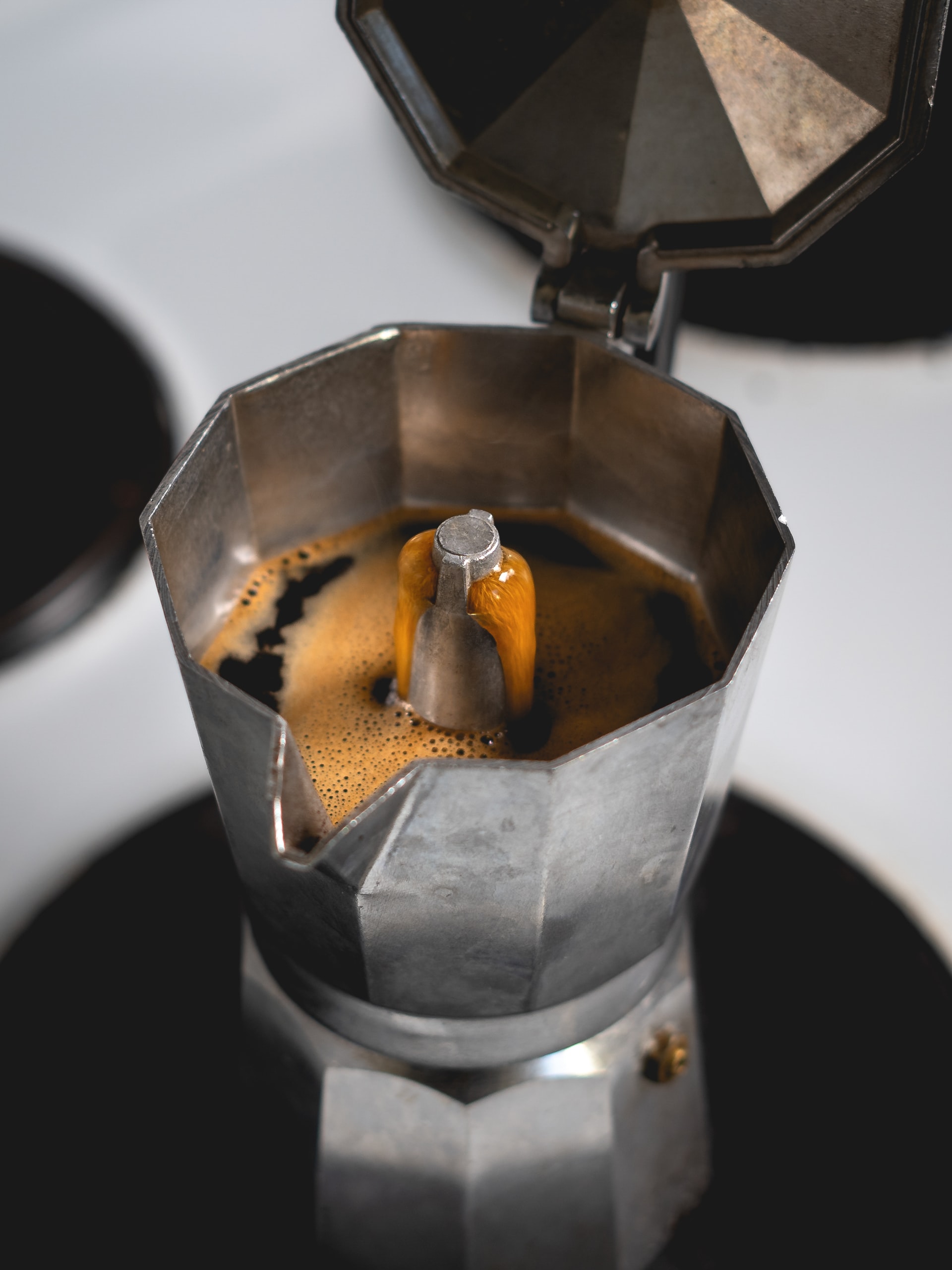 Espresso coffee brewing in a traditional moka pot machine Espresso coffee brewing in a traditional moka pot machine