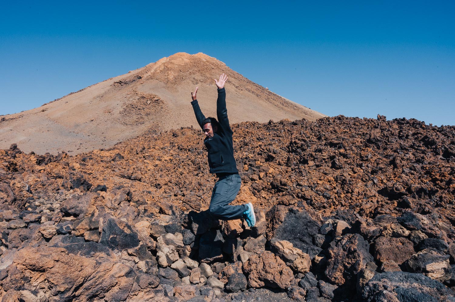 Man jumping in Teide mountain in Tenerife, Spain