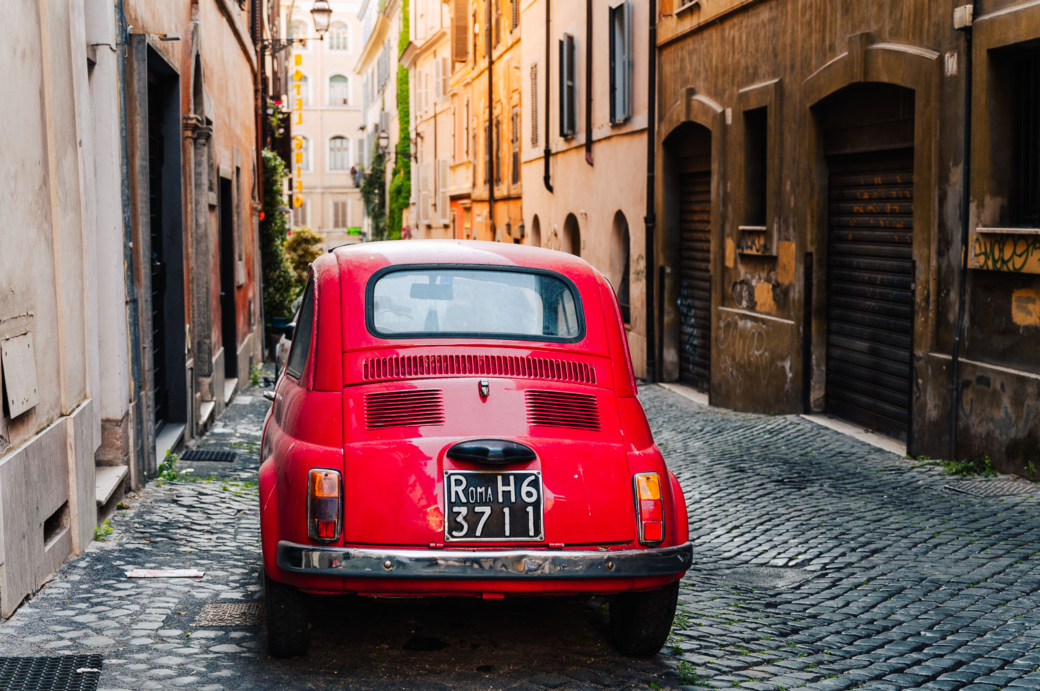 Red Fiat 500 vintage car in Monti neighbourhood in Rome, Italy