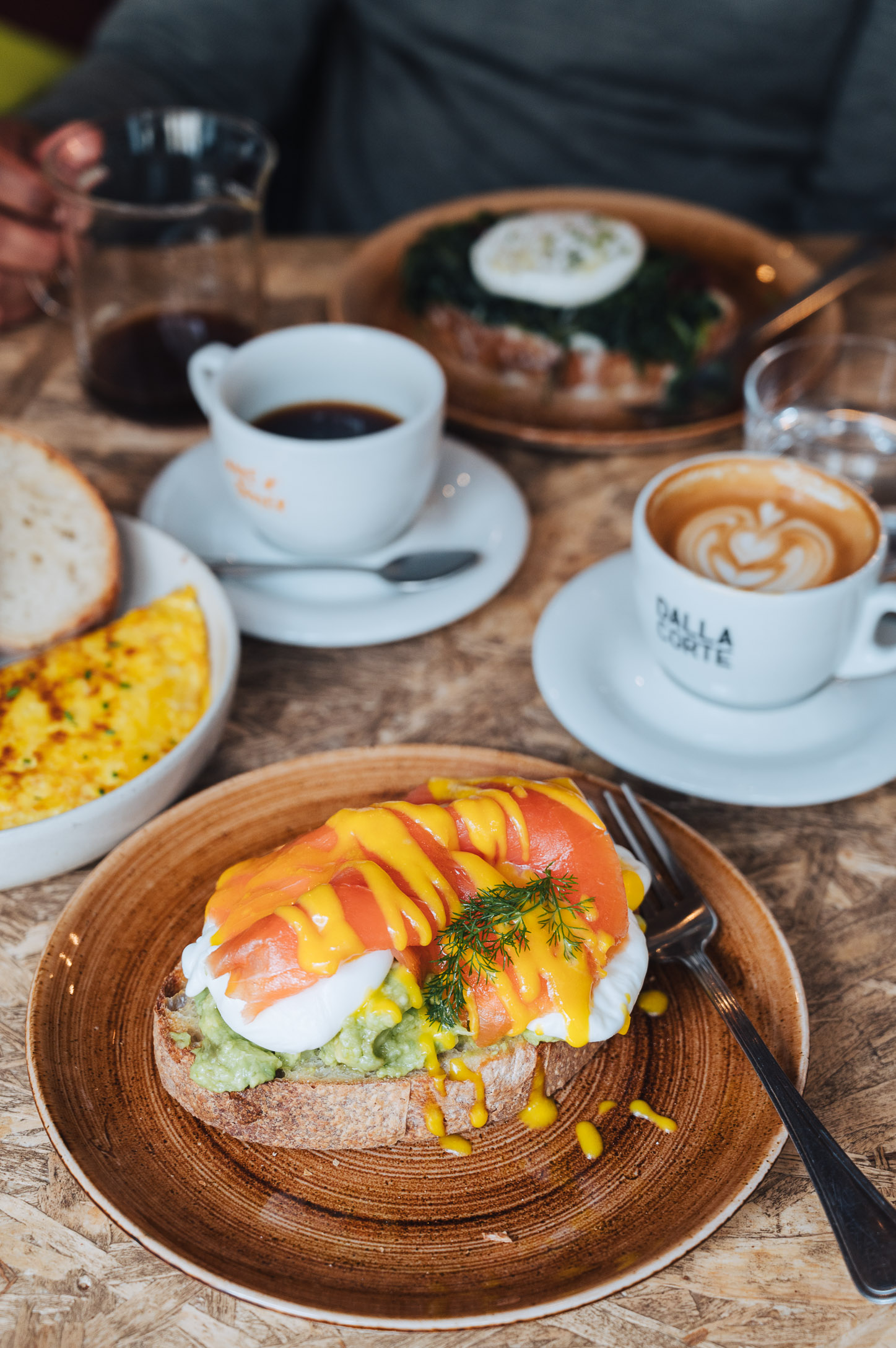 Breakfast dish with eggs and salmon and coffee cups on a table at Sensorio Coffee Lab in Rome  Breakfast dish with eggs and salmon and coffee cups on a table at Sensorio Coffee Lab in Rome