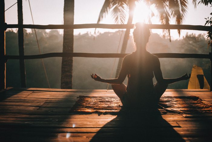 woman meditating in bali at sunrise