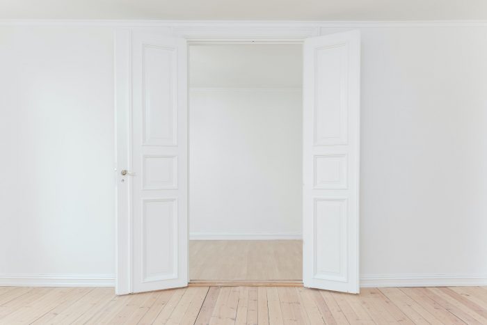 Minimalist photography of white walls and a door