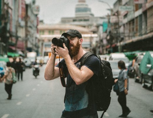Young man travelling photographer Canon