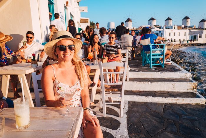 Sunset drinks, young girl, Mykonos island, Greece