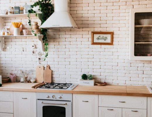 white kitchen with tiles and wooden counter