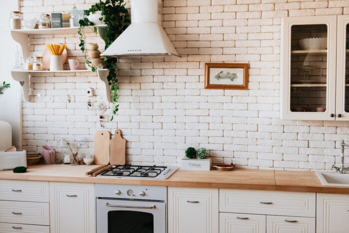 white kitchen with tiles and wooden counter white kitchen with tiles and wooden counter