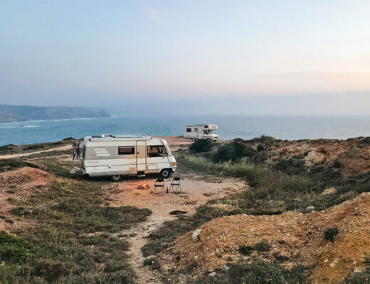 White RV motorhomes parked on a cliff on Praia do Amado, Carrapateira, Portugal