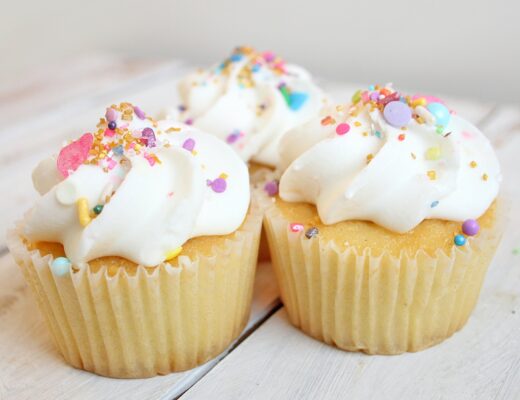 vanilla cupcakes with frosting and sprinkles