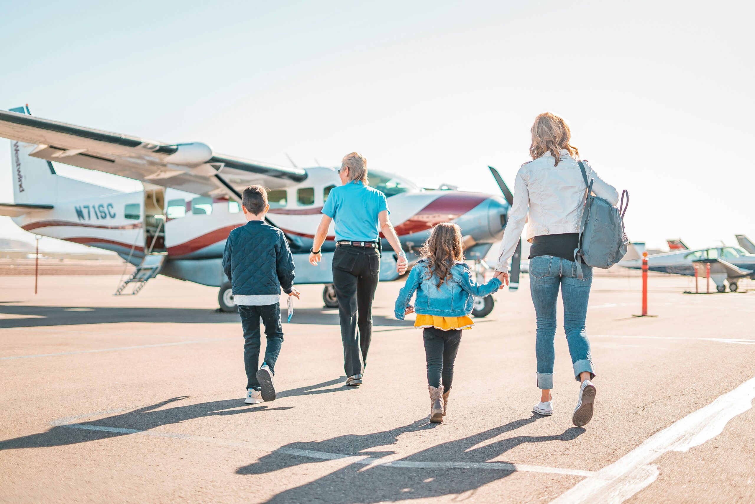 Family walking to an airplane - travel