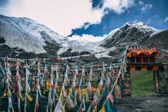 multicolour flags under snow mountain in Tibet multicolour flags under snow mountain in Tibet