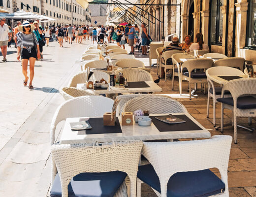 Outdoor restaurant tables on a street in the old town of Dubrovnik, Croatia