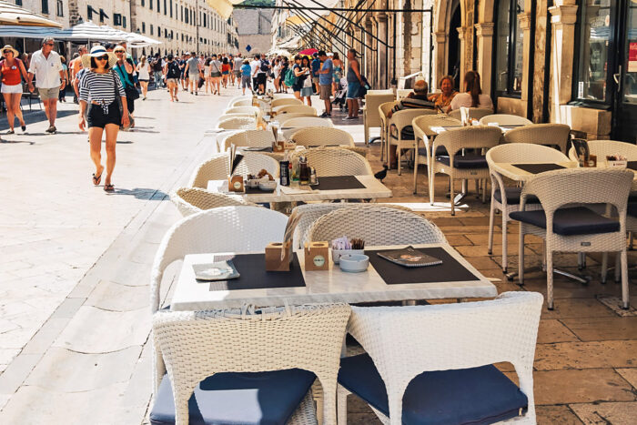 Outdoor restaurant tables on a street in the old town of Dubrovnik, Croatia Outdoor restaurant tables on a street in the old town of Dubrovnik, Croatia