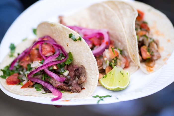 Tacos on a paper palte at a street food festival