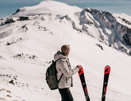 skier standing next to the skis in the snow mountains