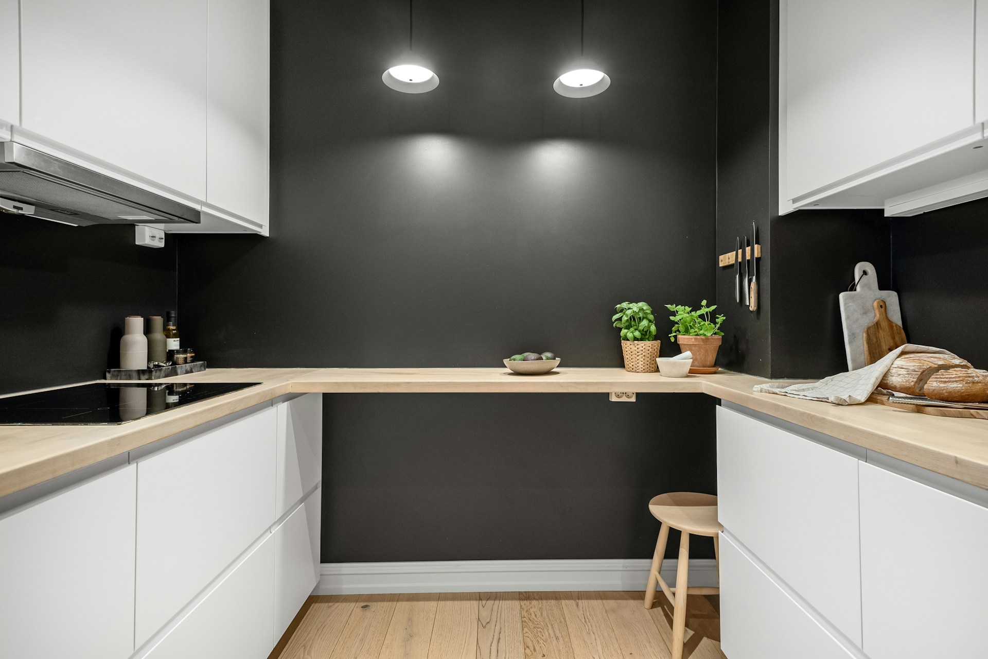 black wall and white cabinets in a kitchen