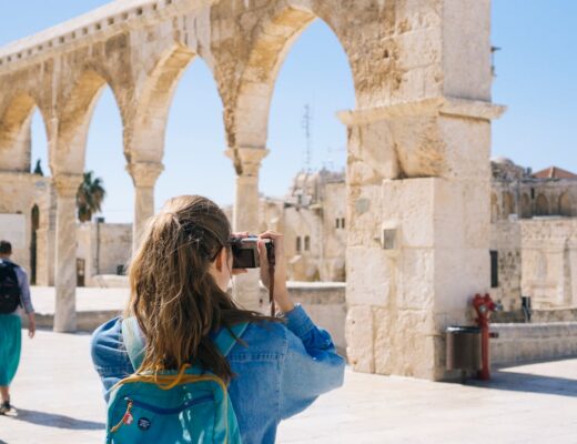 Woman travelling and taking photos of the old town of Jerusalem