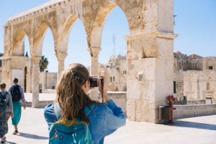 Woman travelling and taking photos of the old town of Jerusalem Woman travelling and taking photos of the old town of Jerusalem