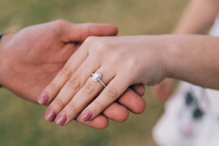 photo of a woman's hand with an engagement ring