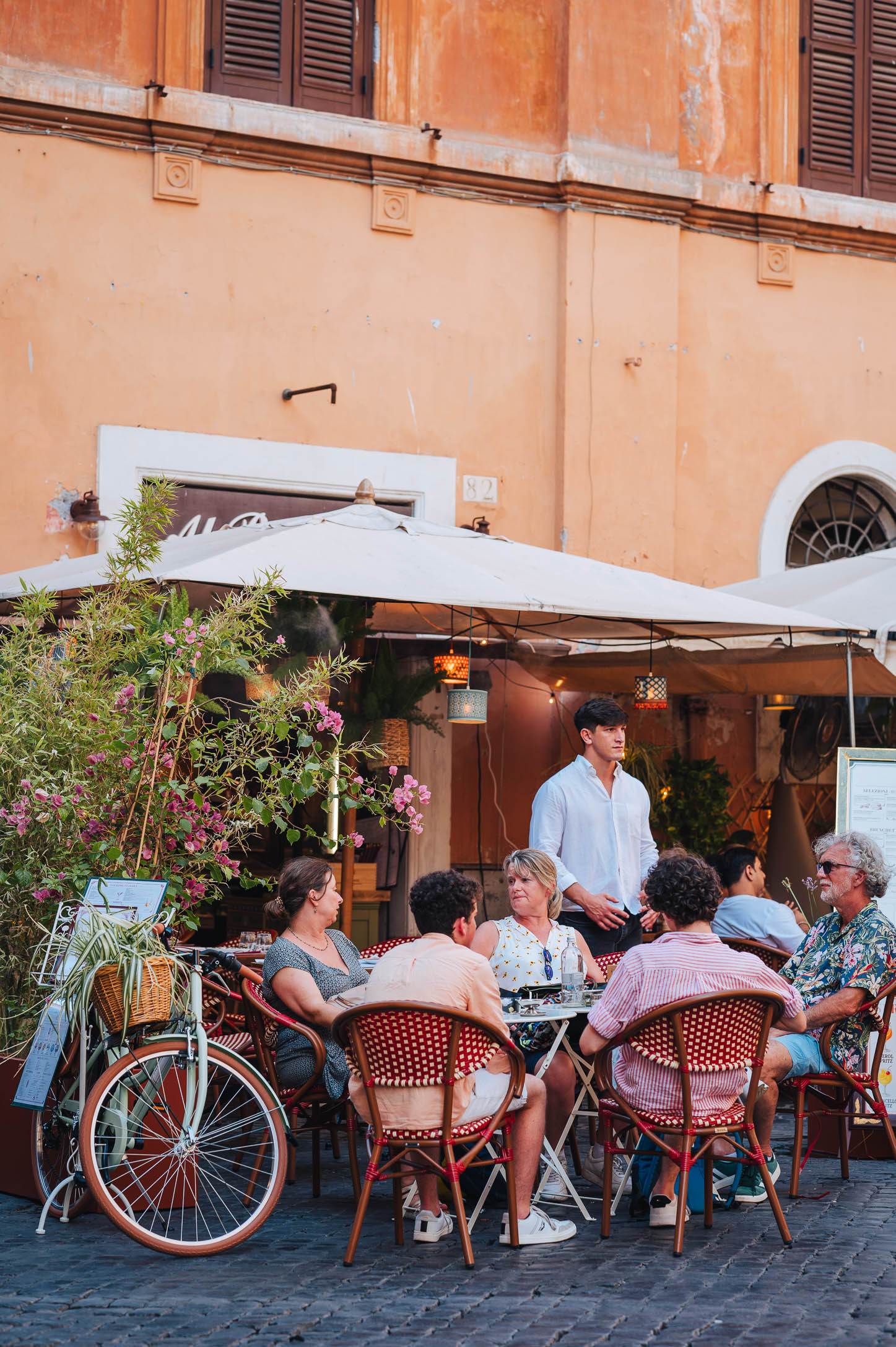 A group of friends eating at a restaurant's table in Rome Campo de' Fiori Italy