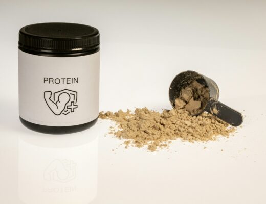 a jar of protein powder on a white table
