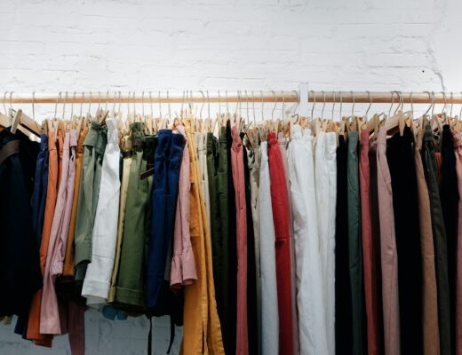 assorted colourful clothes hanging from a clothing rack