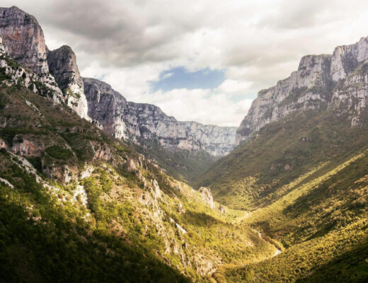 clouds over valley in mountains in greece, vikos gorge greece