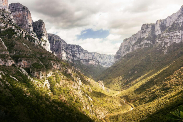 clouds over valley in mountains in greece, vikos gorge greece