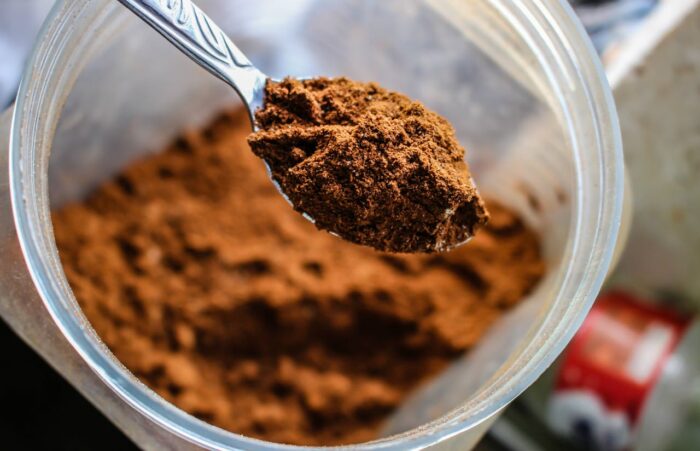 a spoon of brown powder from a jar a spoon of brown powder from a jar