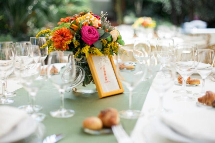 table setting with flowers and glasses at a wedding in italy table setting with flowers and glasses at a wedding in italy