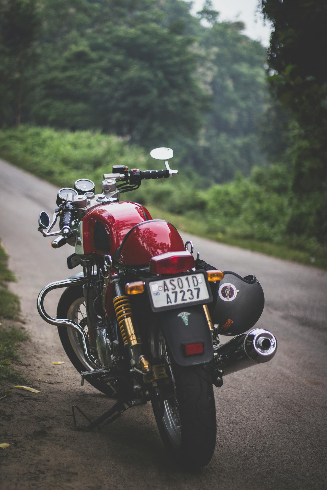 red motorcycle parked on a mountain road