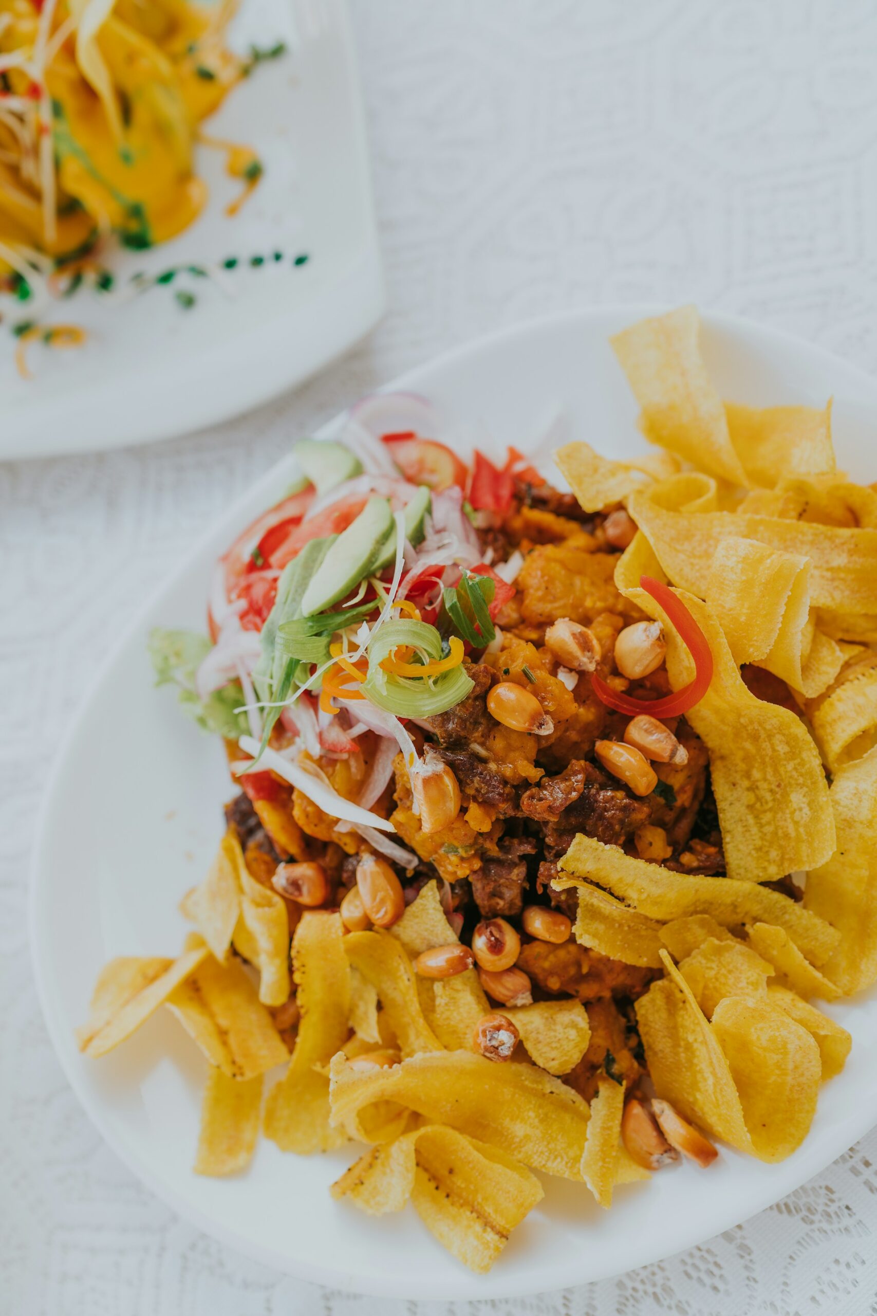 potato fries and corn on white ceramic plate in Peru potato fries and corn on white ceramic plate in Peru