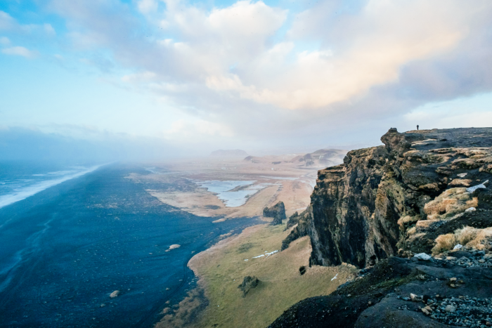 aerial photo of mountain over water in Vik, Iceland aerial photo of mountain over water in Vik, Iceland