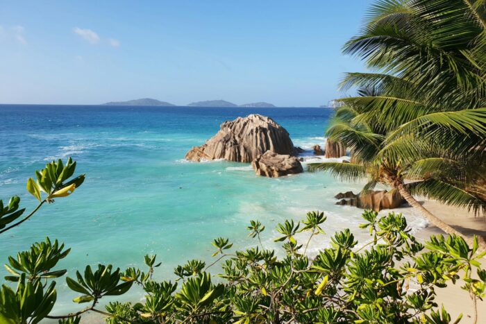 large rocks on island with blue sea water photo in Seychelles