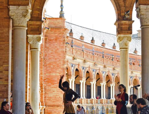 A flamenco dancer dancing near old buildings in Seville, Spain