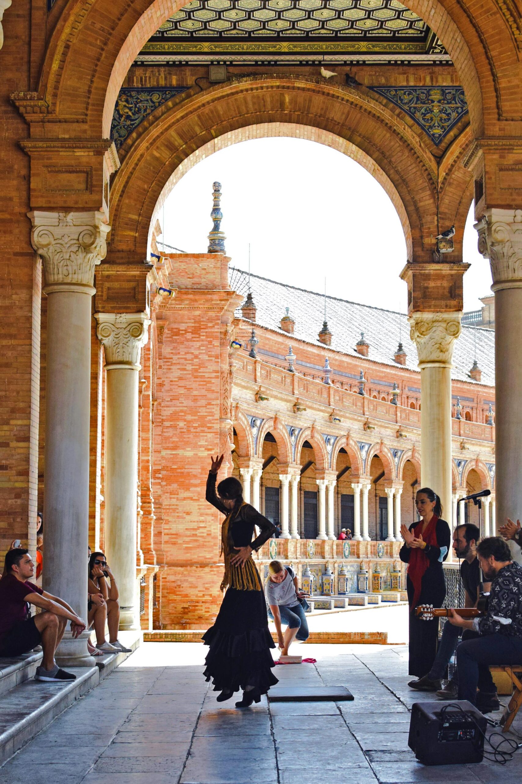 A flamenco dancer dancing near old buildings in Seville, Spain