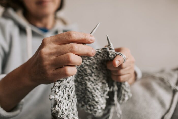 a woman knitting wool a woman knitting wool
