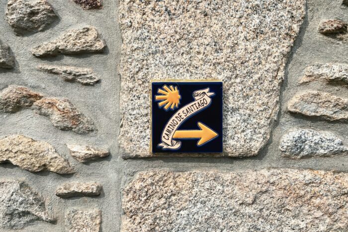 camino de santiago sign on wall in spain