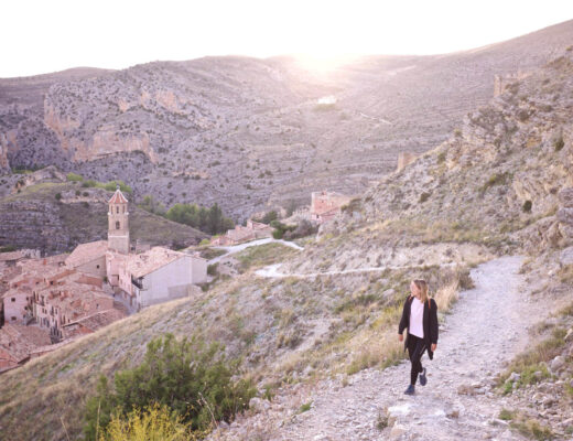 woman walking on a hill near a village in spain