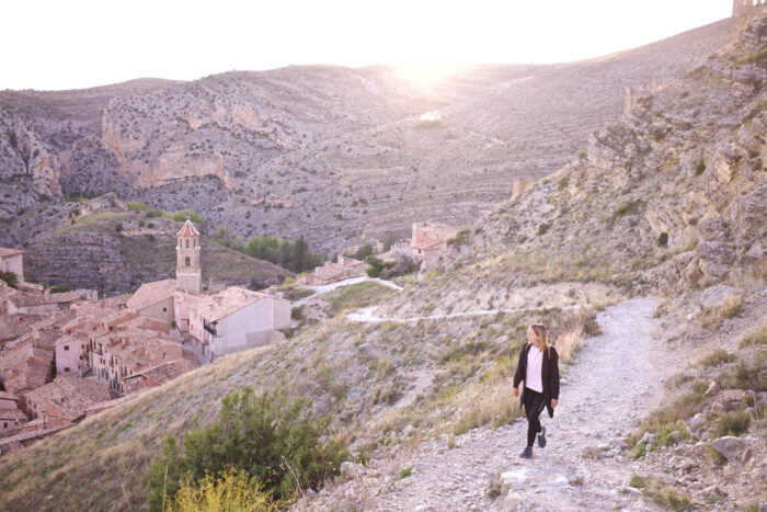 woman walking on a hill near a village in spain