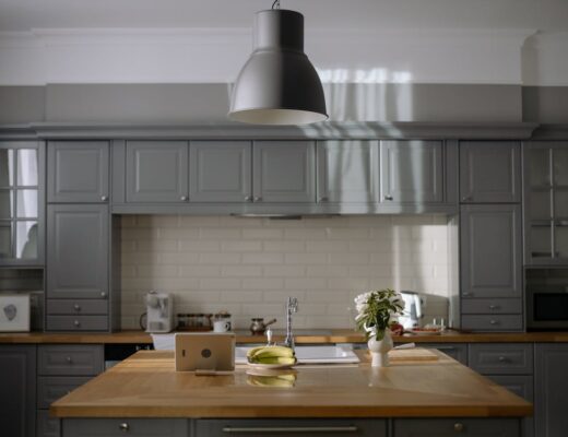wooden table in the middle of gray kitchen