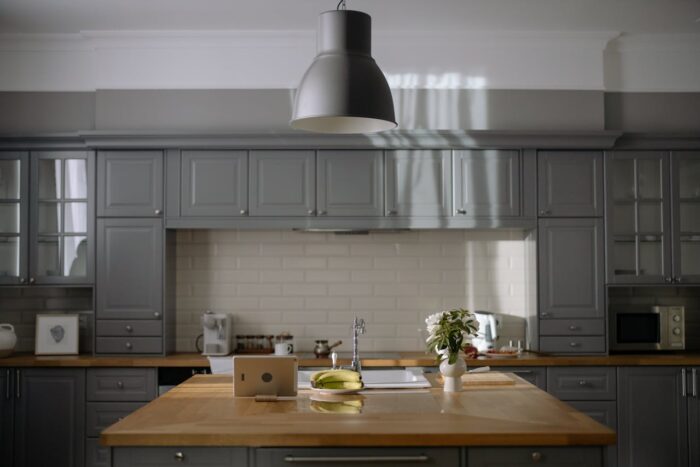wooden table in the middle of gray kitchen