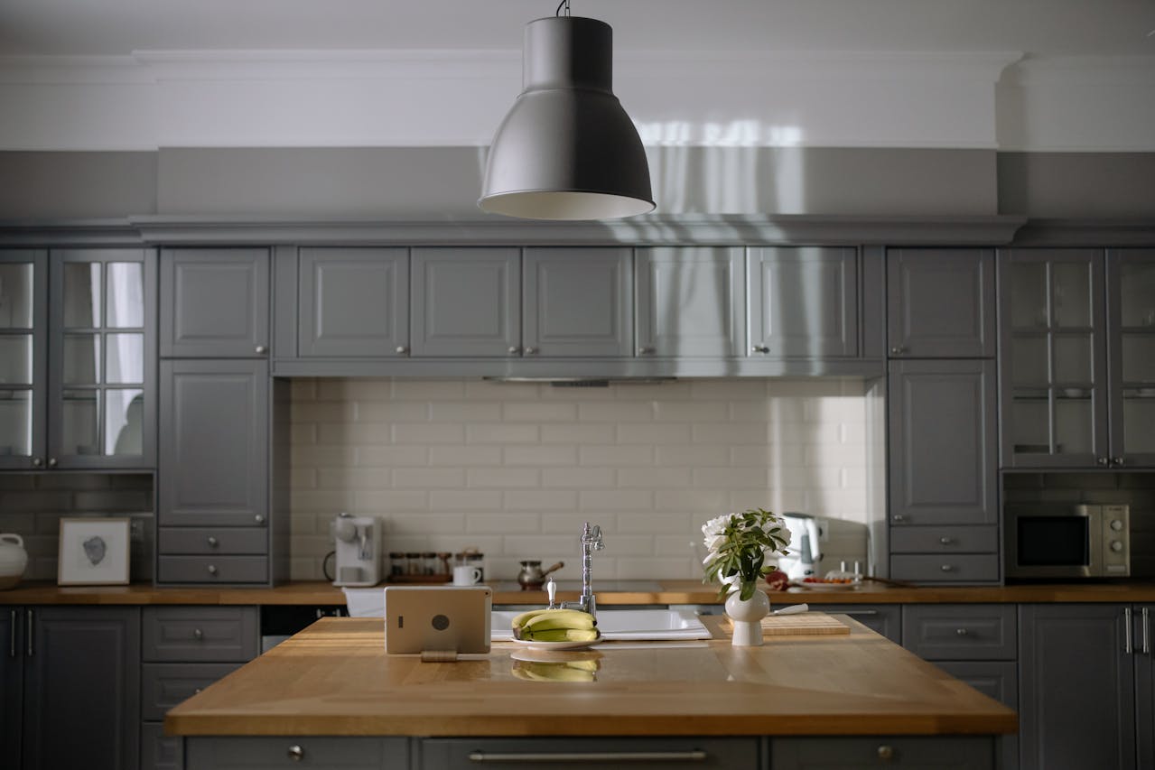 wooden table in the middle of gray kitchen